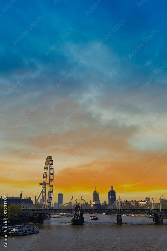 A view along the Thames in London, UK at dusk.