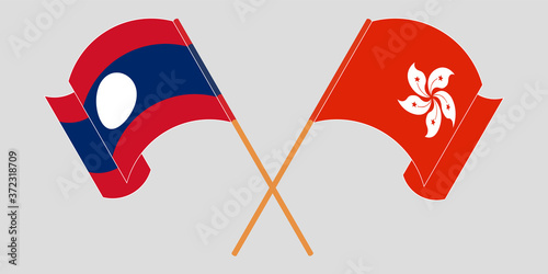 Crossed and waving flags of Laos and Hong Kong