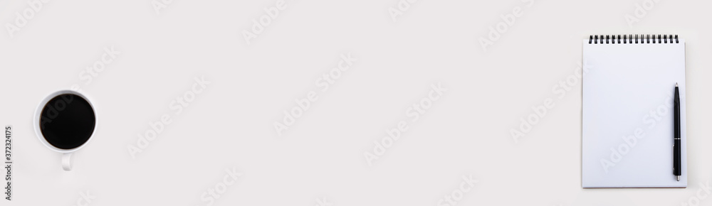 White notepad mockup with black pen and cup of coffee on light table, top view . free space for text. banner White notepad mockup with black pen and cup of coffee on light table, top view . free space for text. banner