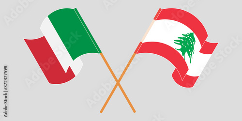 Crossed and waving flags of Lebanon and Italy