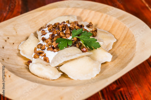 Traditional Slovak food - Bryndzove pyrohy with bacon on plate. The food in the restaurant. Food styling and restaurant meal serving. photo