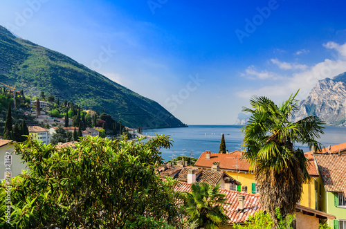 View of Lake Garda and the surrounding mountains from the town Torbole. Northern Italy