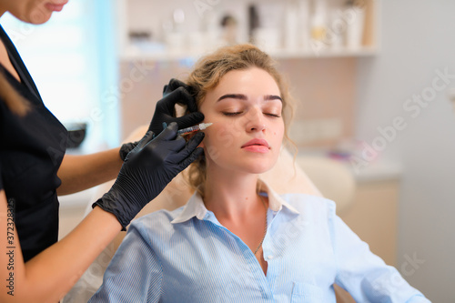 Biorevitalization, face injections in a beauty salon
