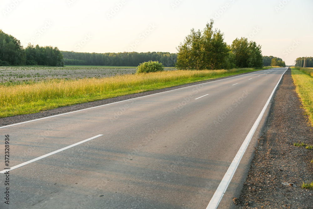 Fototapeta premium empty country road at sunset