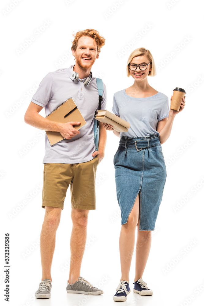 Fototapeta premium Students with books and disposable cup looking at camera on white background