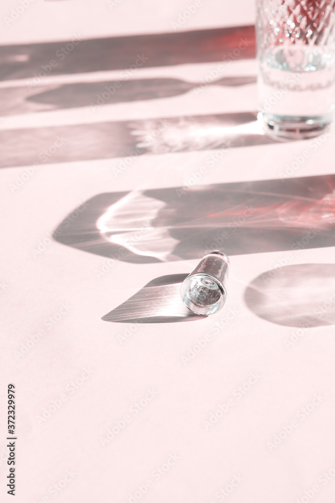 Beautiful shadows from crystal glasses of various shapes. Shadows on a pink background Beautiful shadows from crystal glasses of various shapes. Shadows on a pink background