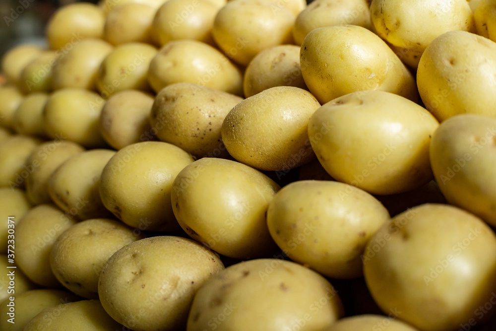 potatoes arranged symmetrically at a market stall potatoes arranged symmetrically at a market stall