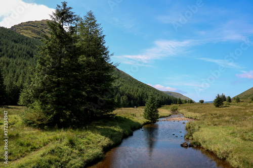Fototapeta Naklejka Na Ścianę i Meble -  Small Highland River and Mountain in Scotland