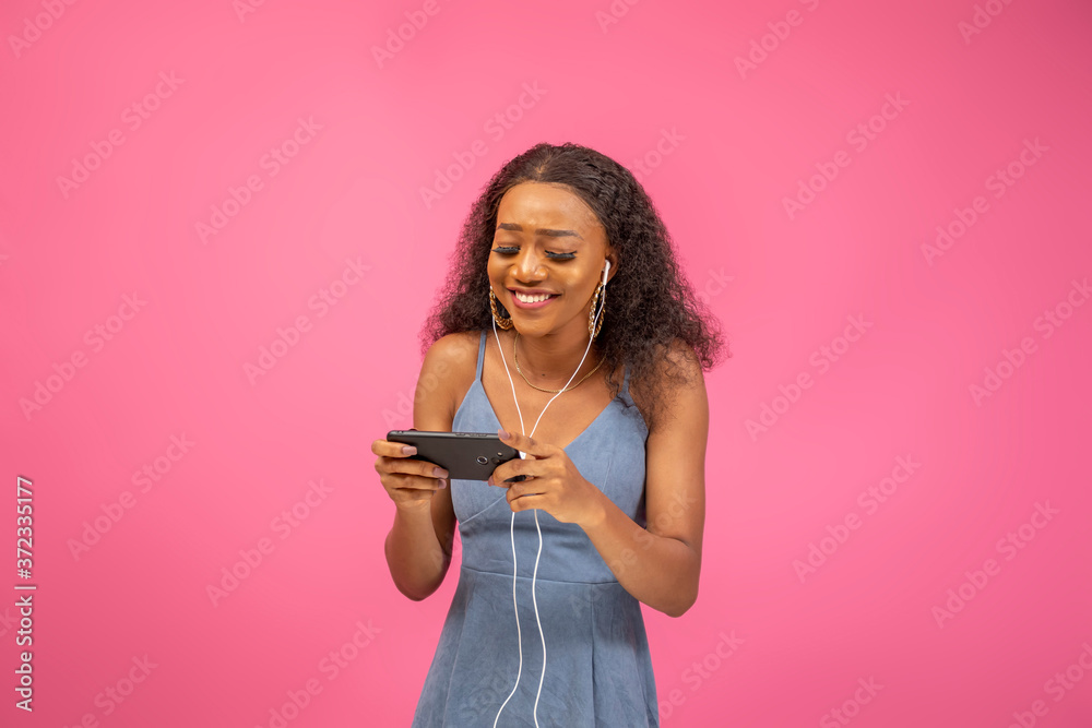 pretty black lady watching something entertaining on her phone pretty black lady watching something entertaining on her phone
