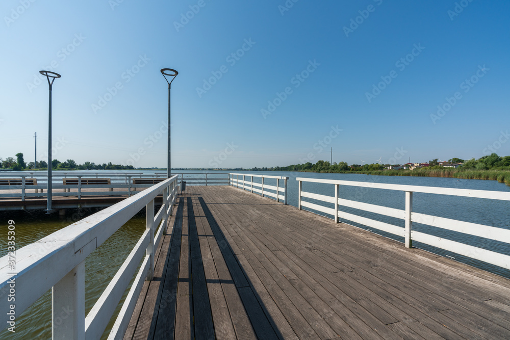 Pier on a small lake in the town of Znin on a sunny summer day