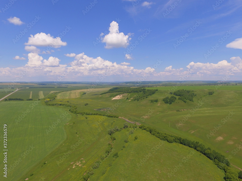 Green field and blue sky with clouds. The view from the top. Tatarstan, Russia