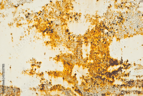 Texture of an old metal fence. Scratched metal sheet with yellow paint. © Ivan