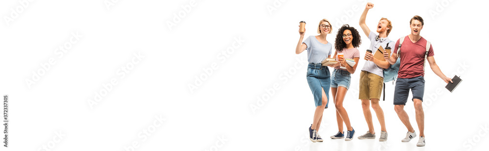 Panoramic shot of multiethnic students holding books and coffee to go on white background