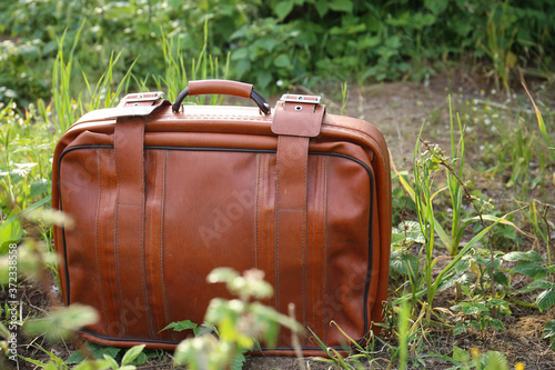 Old suitcase on the background of nature