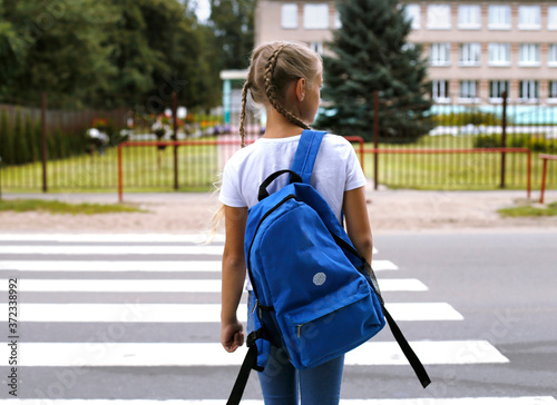 Fotografiet European blonde girl goes to school