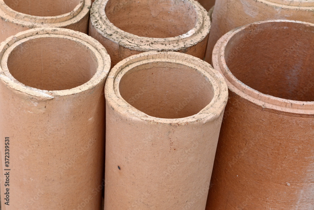Warehouse. chamotte pipes for chimneys. modular chimney, close-up Warehouse. chamotte pipes for chimneys. modular chimney, close-up