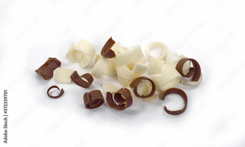 Group of chocolate shavings. White and black Chocolate Curls Isolated On White Background. Chocolate roll. Group of chocolate shavings. White and black Chocolate Curls Isolated On White Background. Chocolate roll.