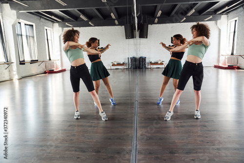 Two young women practicing together in dance studio