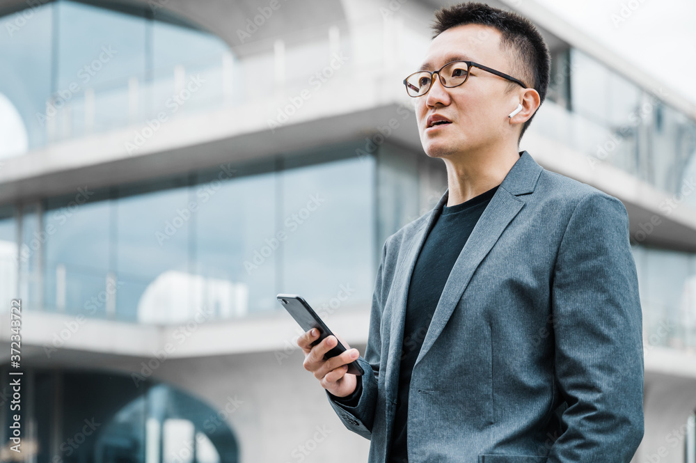 Businessman using cell phone and bluetooth headset Businessman using cell phone and bluetooth headset