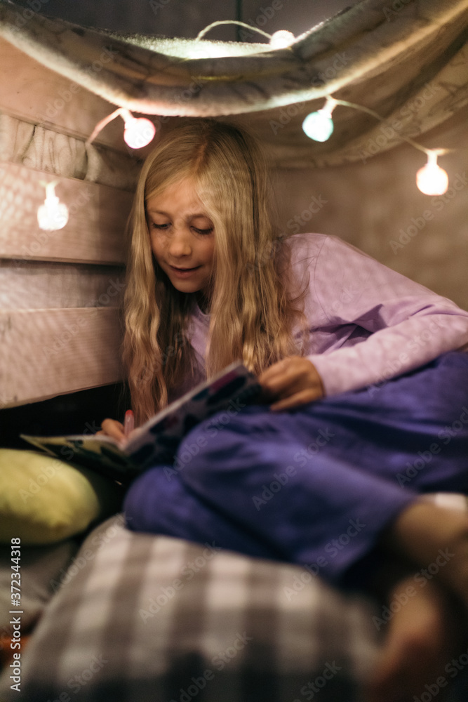 Kid playing in her tiny home, inside the room. Kid playing in her tiny home, inside the room.