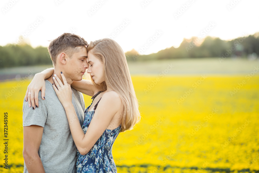 Young beautiful couple poses on nature in field. Young beautiful couple poses on nature in field.
