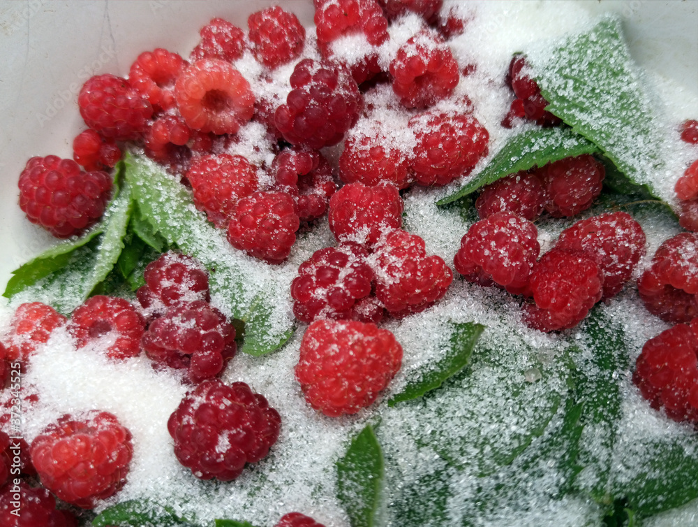 photo of raspberries and mint leaves with white sugar. ingredients for mojito. Top view