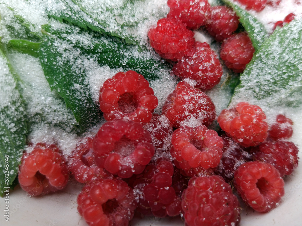 photo of raspberries and mint leaves with white sugar. ingredients for mojito. Top view