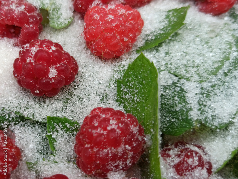 photo of raspberries and mint leaves with white sugar. ingredients for mojito. Top view