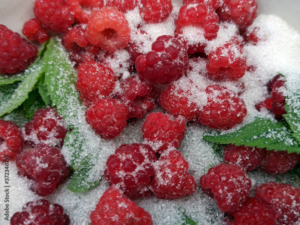 photo of raspberries and mint leaves with white sugar. ingredients for mojito. Top view