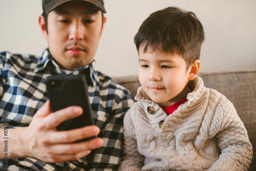 Dad and child looking at phone Dad and child looking at phone