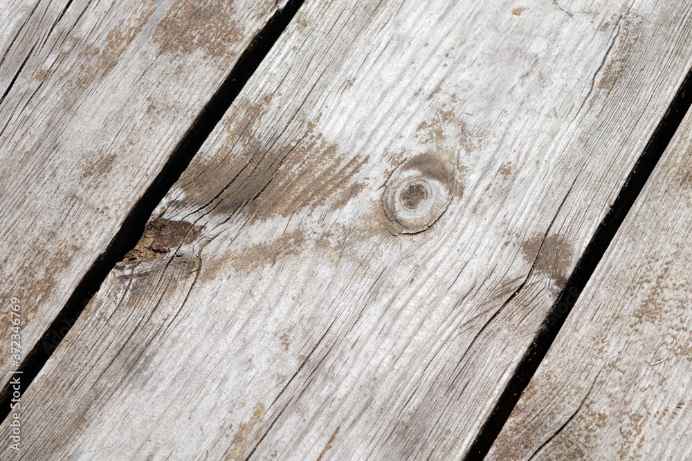 Obraz premium Angled photo of a board with a small knot on a wooden pier