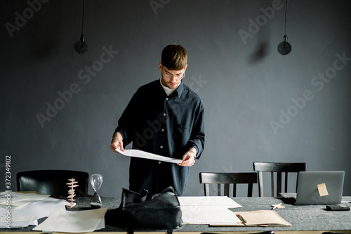 Male designer examining sketch in office photo