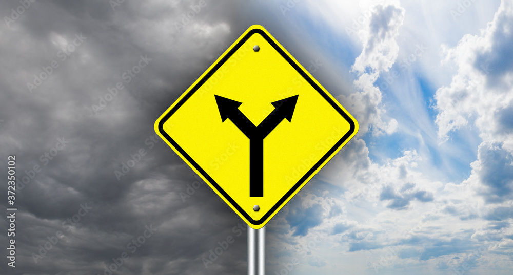 A fork in the road warning sign. Choosing the path of development. Direction of movement. Concept - the result depends on the correct choice. A fork in the road warning sign. Choosing the path of development. Direction of movement. Concept - the result depends on the correct choice.
