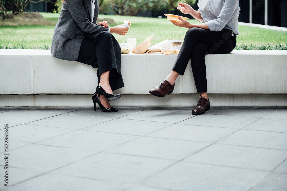 Businessman and businesswoman eating lunch together Businessman and businesswoman eating lunch together