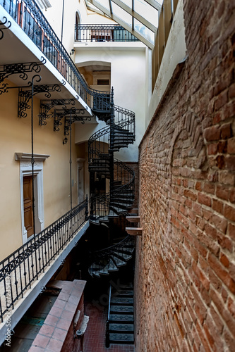 The spiral staircase in the yard of Bandinelli Palace, Market Square, Lviv, Ukraine photo