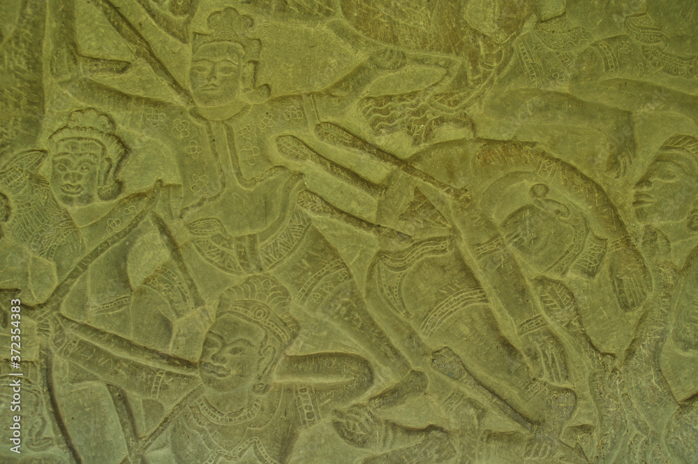 Bas relief carving on a wall of warriors in battle Bas relief carving on a wall of warriors in battle