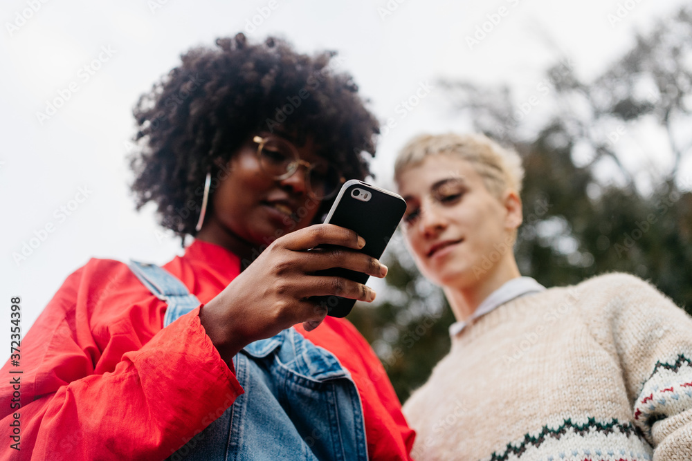 Two women at street with smartphone Two women at street with smartphone