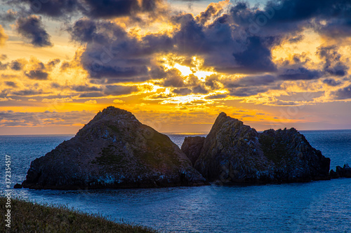 Gull rocks at sunset in Hollywell Bay in Cornwall photo