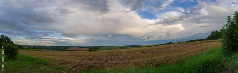 panorama of a landscape field with a sunset sky