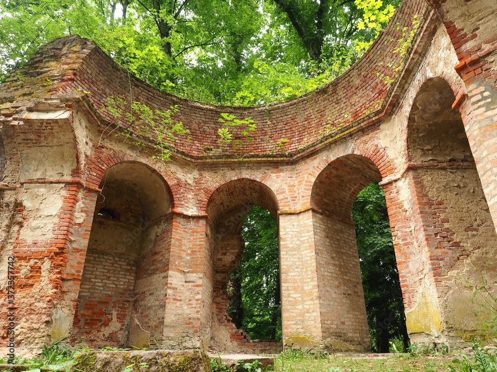 Brick ruin with arches in a forest