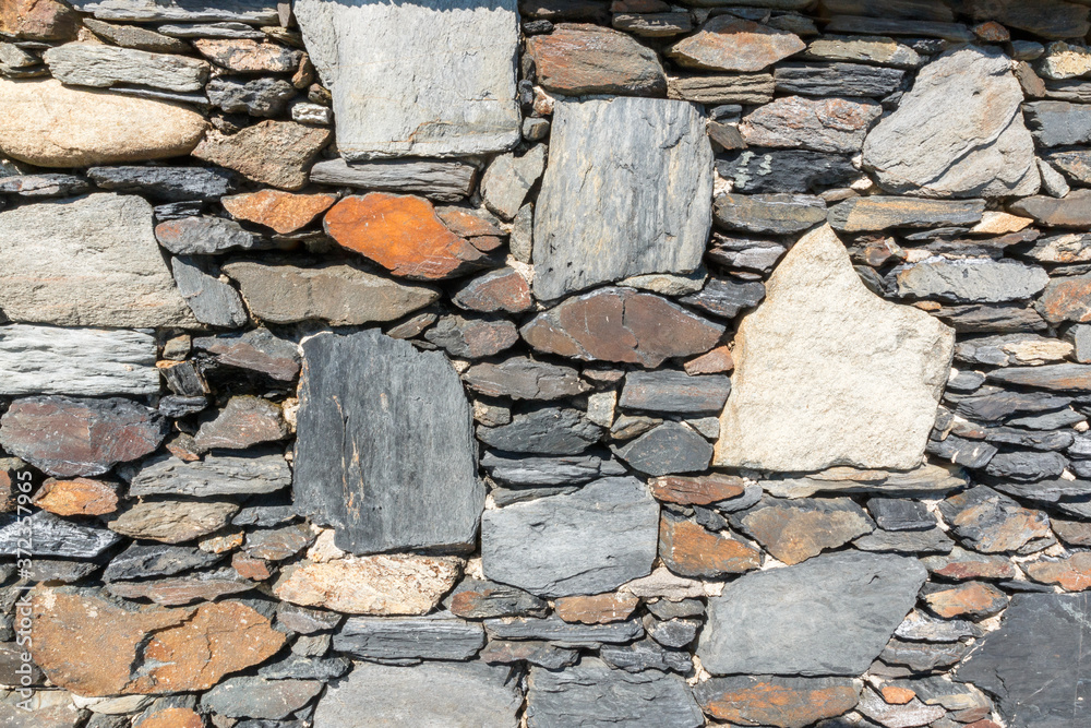 Fototapeta premium Rubble stone wall to be used as background