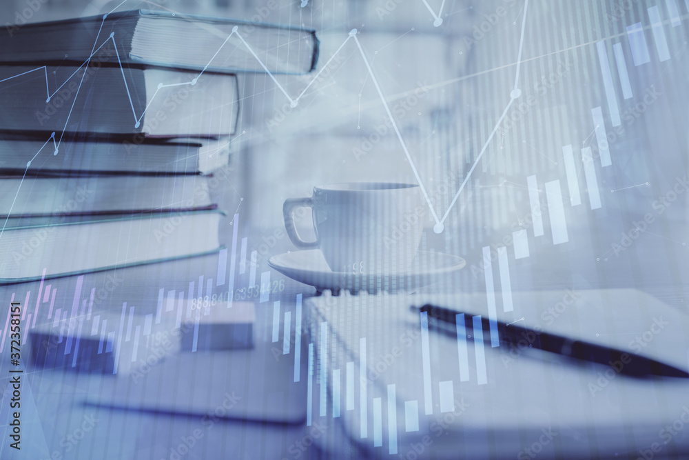 Double exposure of financial chart drawing and desktop with coffee and items on table background. Concept of forex market trading