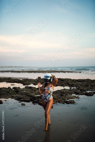 Chica joven  en traje de baño en la playa 