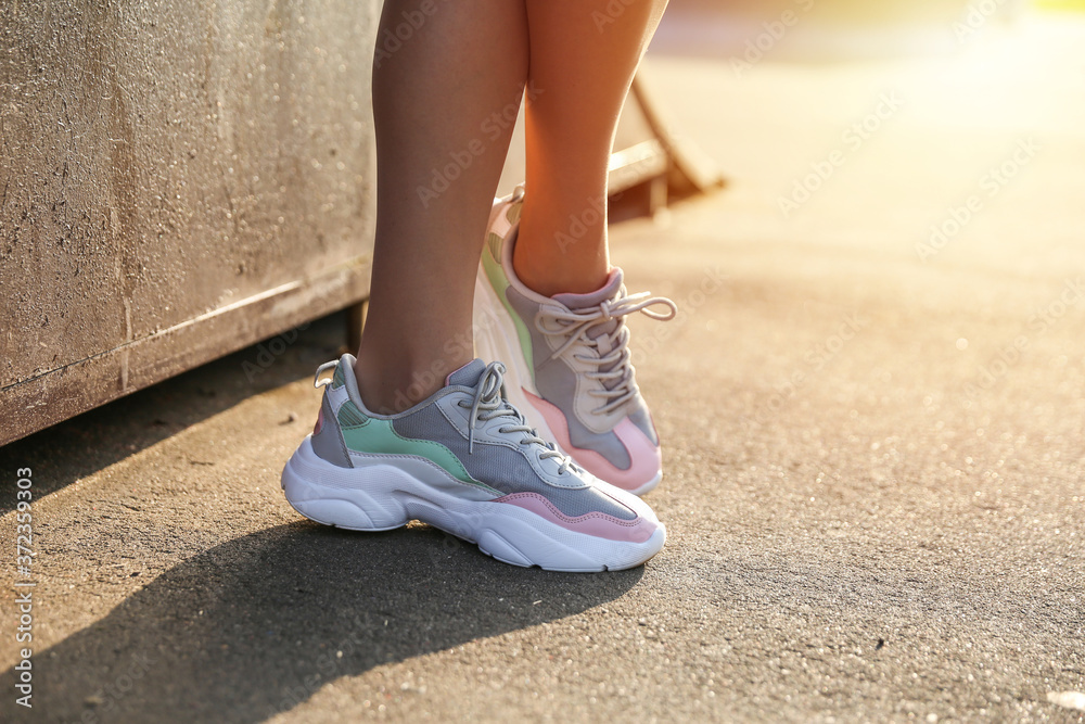 beautiful sports sneakers on women's legs.