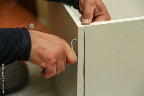 refurbishment in the apartment. assembly of furniture in the house. kitchen cabinet assembling