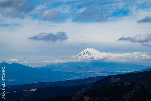 Aerial view of the mount Fuji with layered hills in the foreground. Landscape orientation.