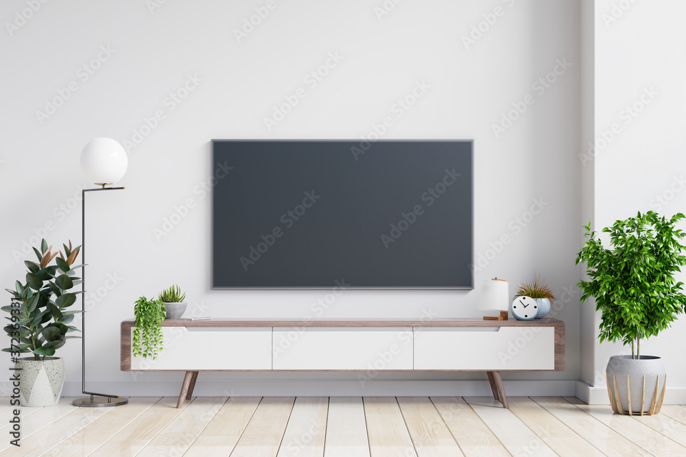 TV on the cabinet in modern living room on white wall background. TV on the cabinet in modern living room on white wall background.