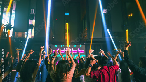 Fotografie crowd of people raise hands and dancing in night club