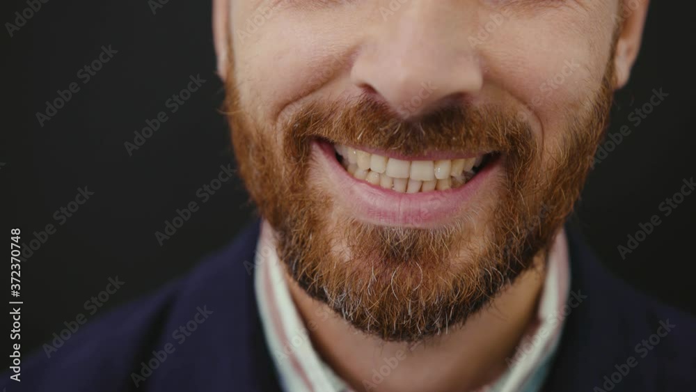 Close up mouth man with teeth smiles at camera dentist portrait, macro lips studio care health slow motion Close up mouth man with teeth smiles at camera dentist portrait, macro lips studio care health slow motion