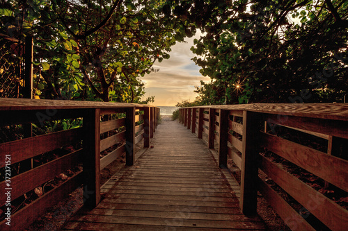 Boardwalk leading toward Delnor Wiggins State Park at sunset photo